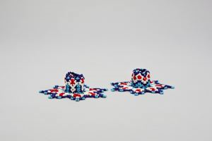 Image: Candleholders with netted beadwork with blue, white, navy, red. 7 pointed star